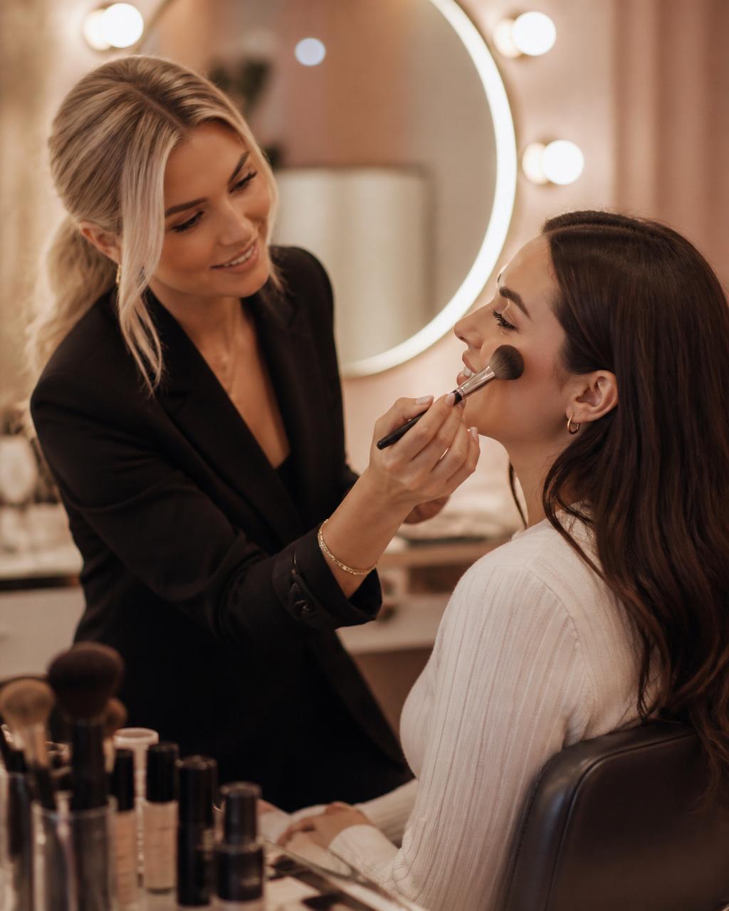 1-on-1 makeup lessons Sydney with a woman applying makeup at a vanity mirror
